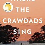 Book cover of Where the Crawdads Sing by Delia Owens. A woman is on a boat in a large river. There are trees on either side of her. The sky is orange and it takes up most of the book cover.
