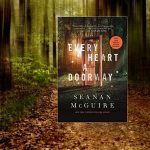 Dark forest with a large pathway. The book featured on the blog is placed in that pathway.